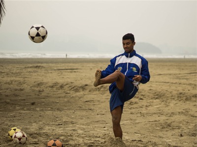 Footballer training on the beach